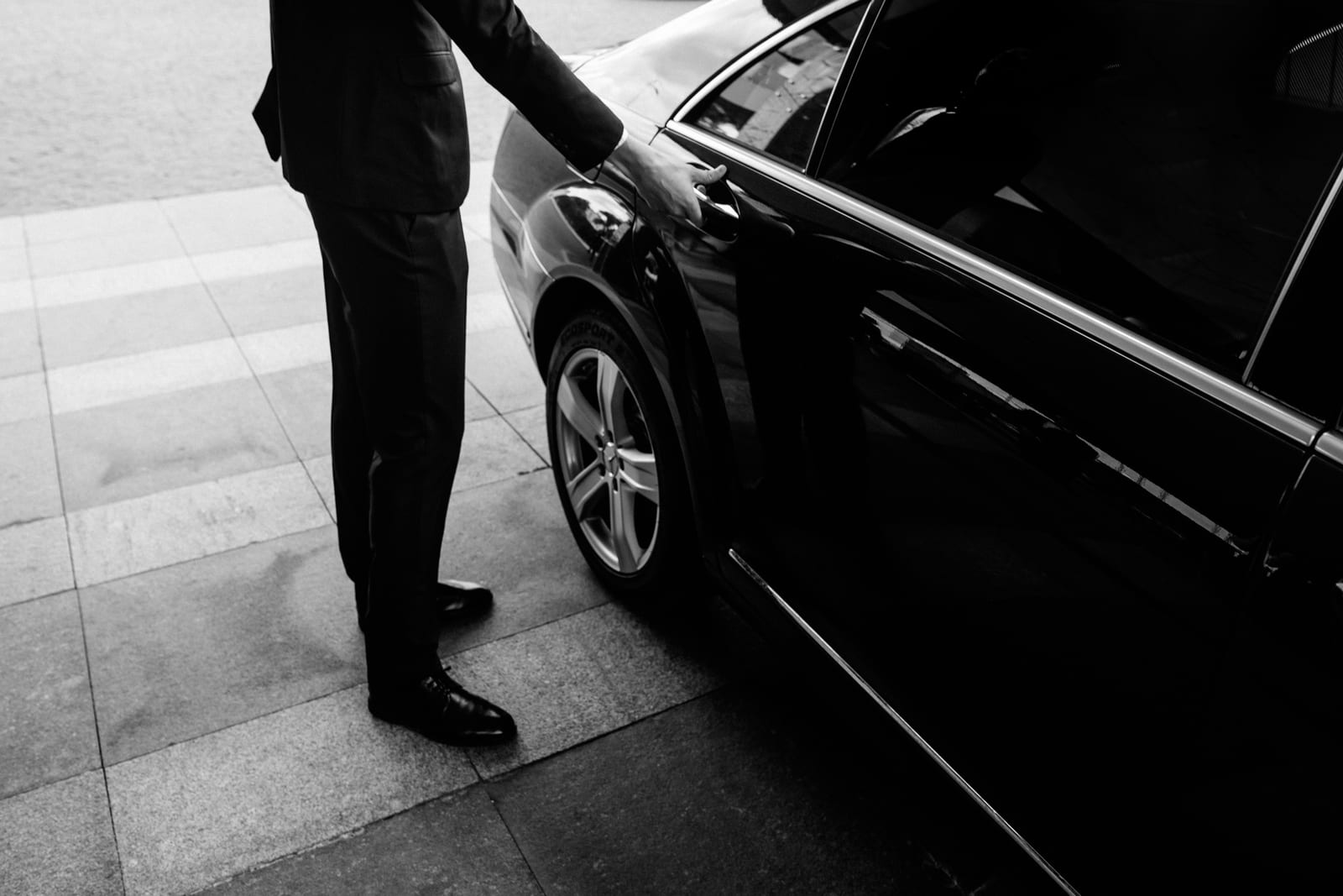 A driver opening a vehicle door