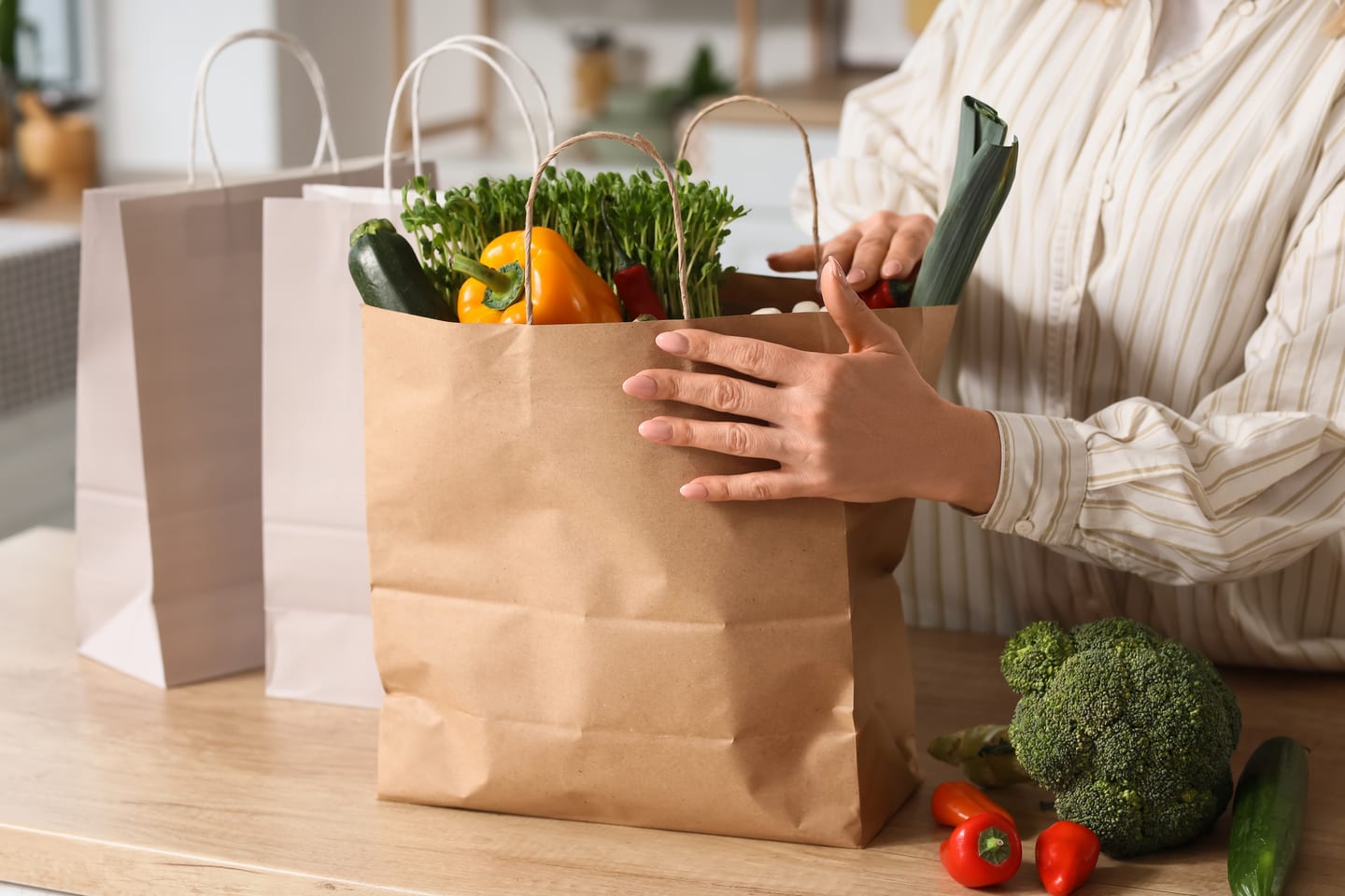 Fresh groceries being unpacked on a kitchen counter